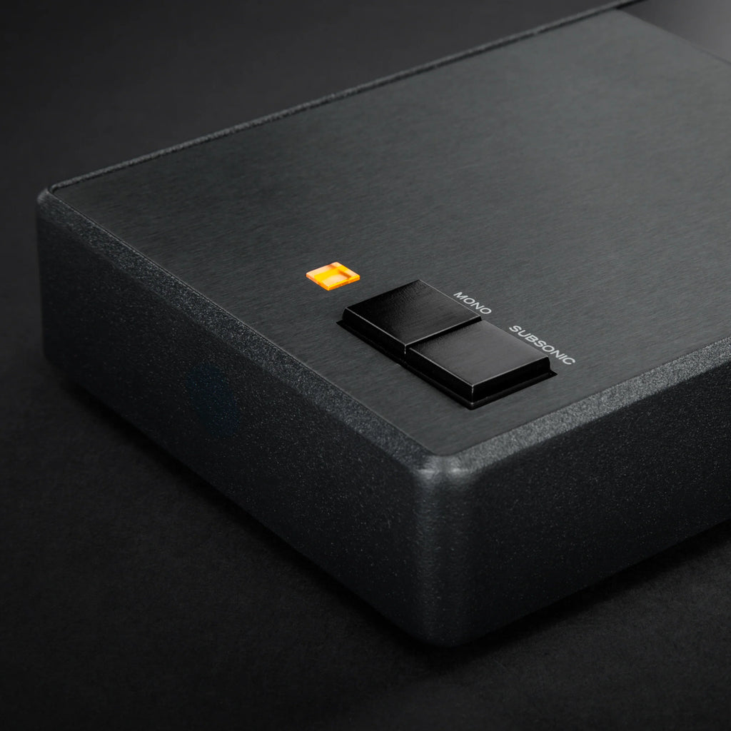 Close-up of MoFi Electronics StudioPhono phono preamp showing input and control knobs on a sleek black device.