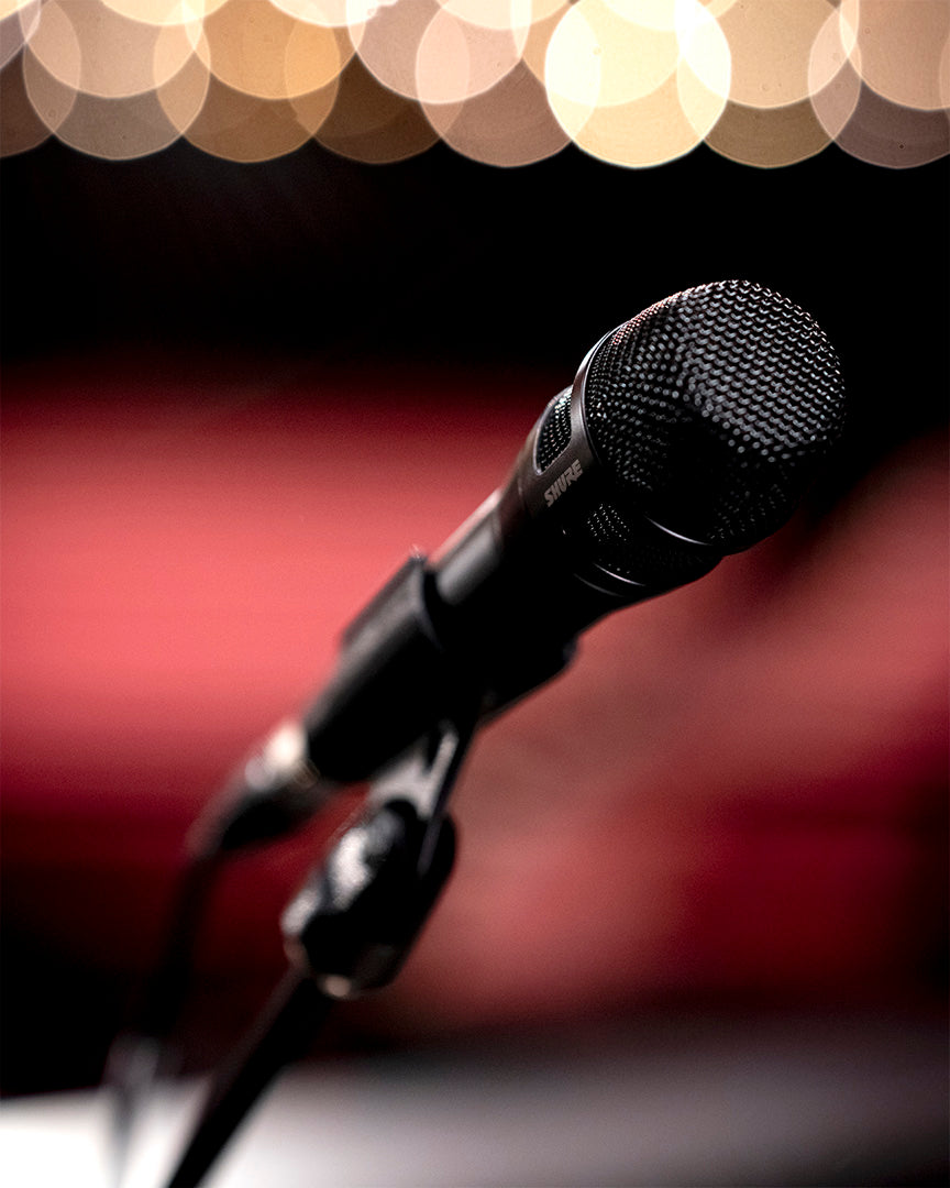 Shure Nexadyne 8/C dynamic handheld microphone with black grille and body, designed for professional live sound applications.
