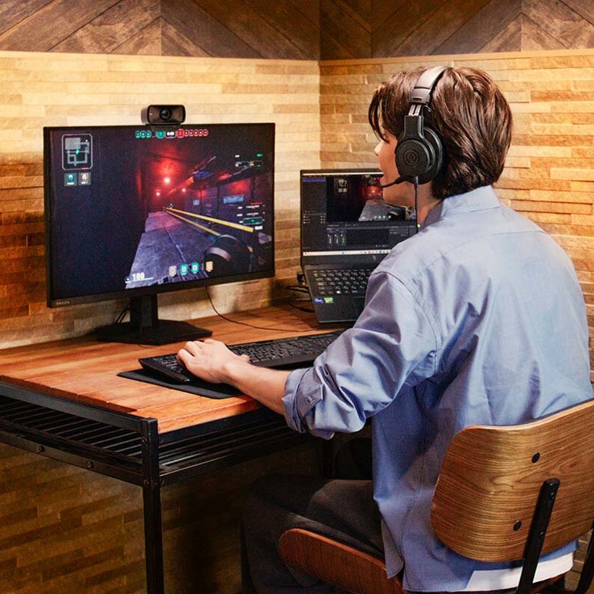 Gamer wearing the Audio-Technica ATH-M20xSTS at a dual-screen desk