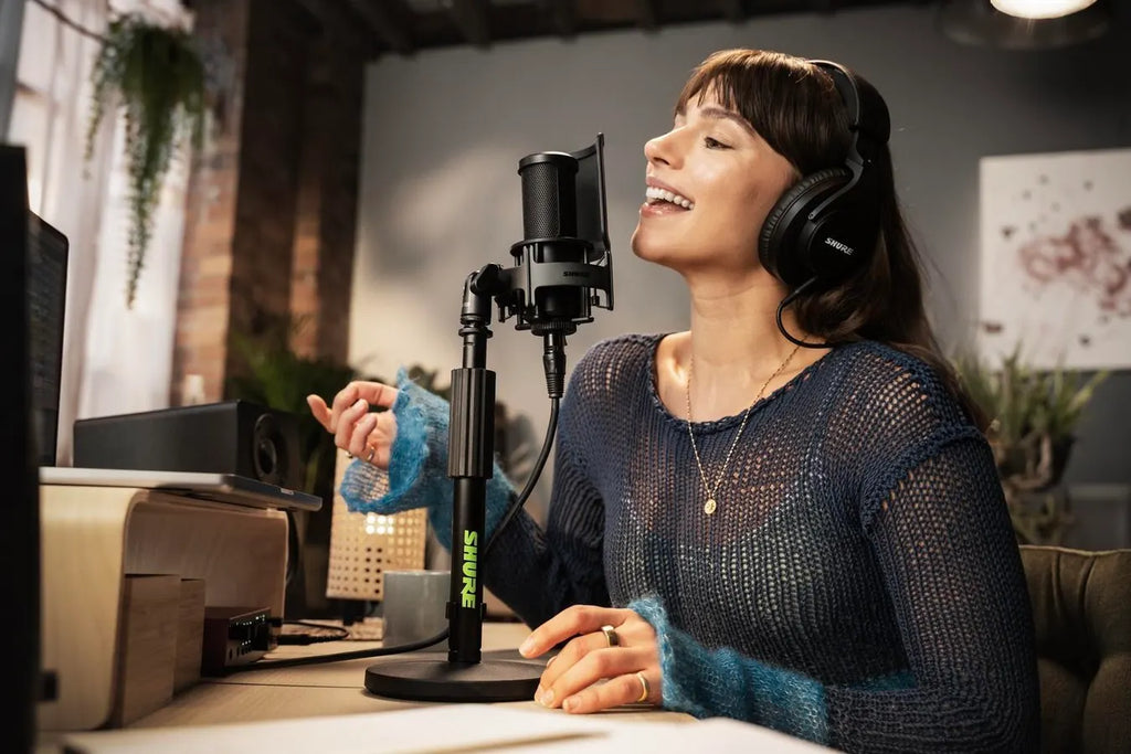 Shure SM4 condenser microphone with a sleek black body and metal grille, ideal for professional audio recording and broadcasting.