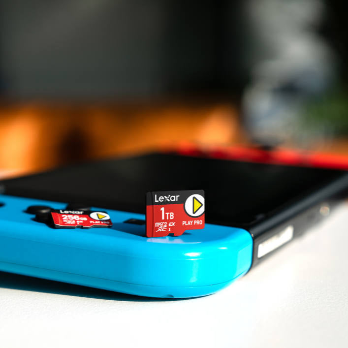 Lexar PLAY PRO microSDXC™ Express memory card lying on a surface with a colorful background, showcasing storage capacity and brand logo.