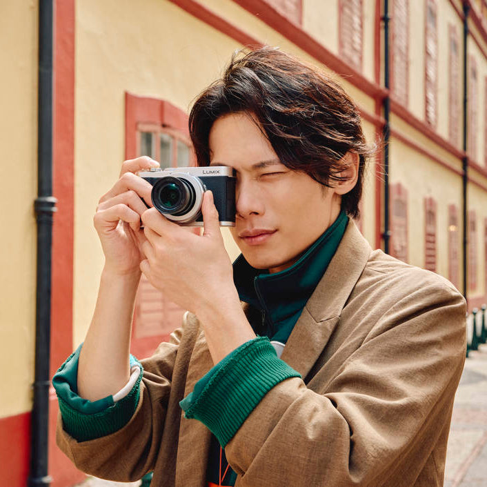 Panasonic Lumix L10 video camera with 1060W lens, showing a sleek black design and adjustable lens focus.