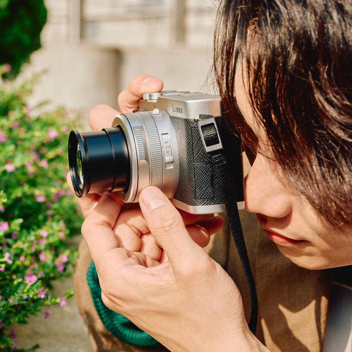 Panasonic Lumix L10 video camera with 1060W lens and advanced features, shown on a white background.