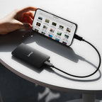 Lexar SL300 Portable SSD external drive shown with sleek black design and USB connection port.