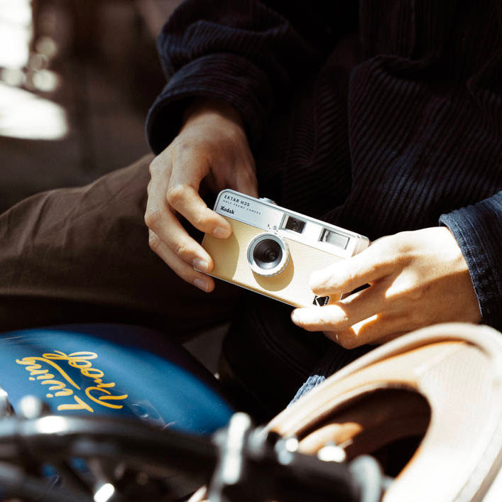 Kodak EKTAR H35 Half Frame Compact Camera for instant photography, showing its sleek design and lens on a neutral background.