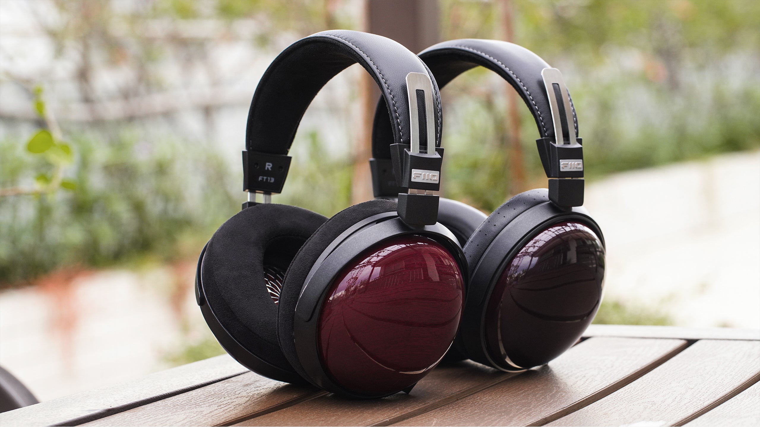 FiiO FT13 wired headphones with black ear cups and silver accents, featuring over-ear design and adjustable headband.