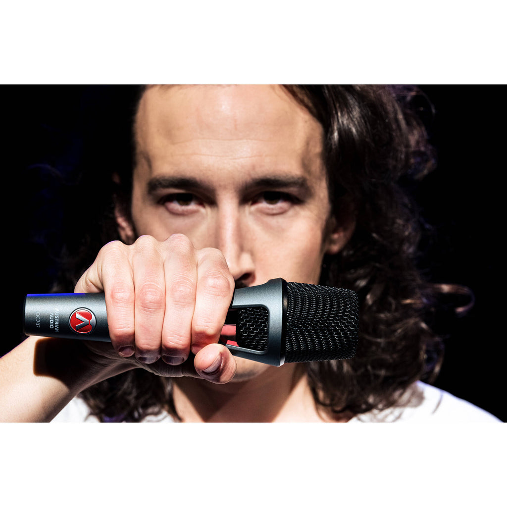 Austrian Audio OC707 condenser microphone with metal grille and black body, positioned on a stand for studio recording.