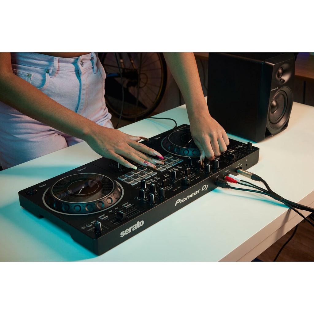 Pioneer DJ DDJ-REV1 black DJ controller with jog wheels, performance pads, and control knobs for professional mixing.