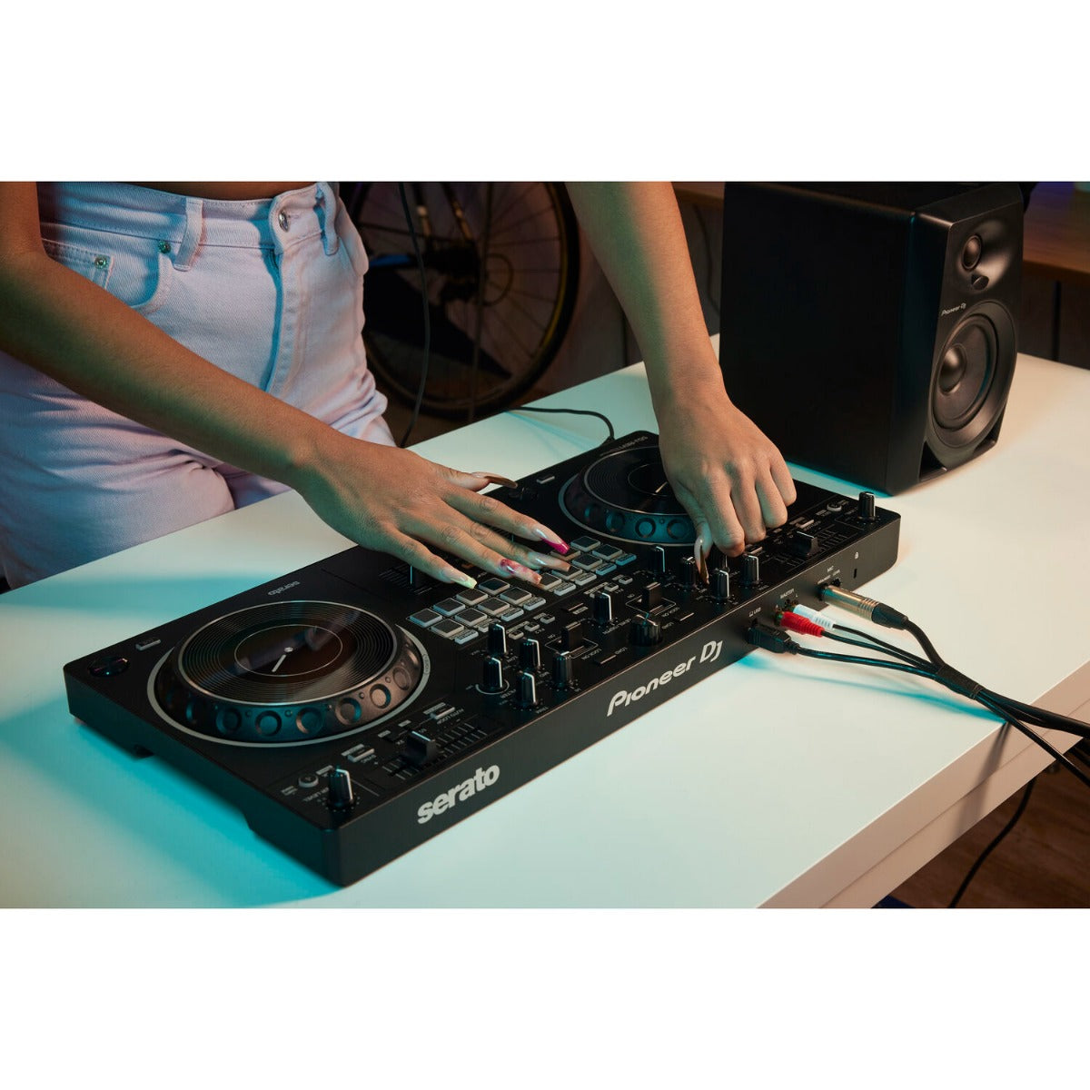 Pioneer DJ DDJ-REV1 black DJ controller with jog wheels, performance pads, and control knobs for professional mixing.