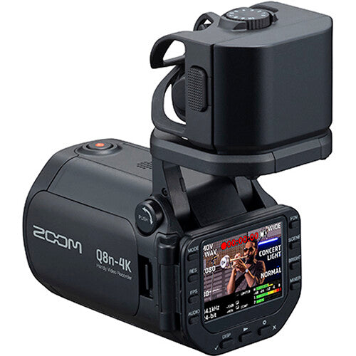 Zoom Q8n-4K video camera with microphones and controls, showing front view with lens and screen in a well-lit setting.