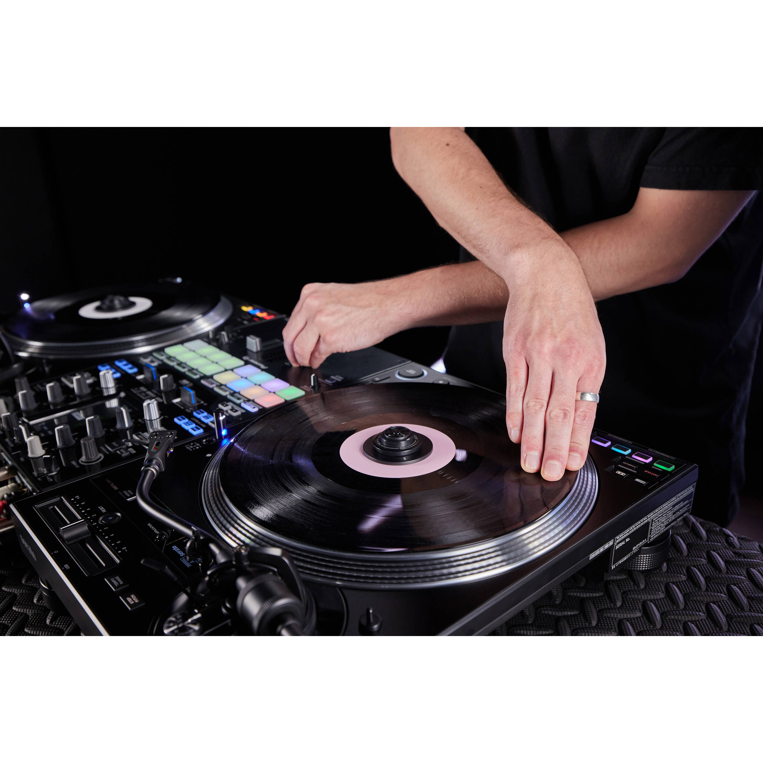 Pioneer DJ PLX-CRSS12 DJ turntable with sleek design and control features, shown with vinyl record on a professional setup.