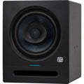Presonus Eris Pro 8 active nearfield studio monitors shown on a desk with audio equipment, highlighting their sleek black design.