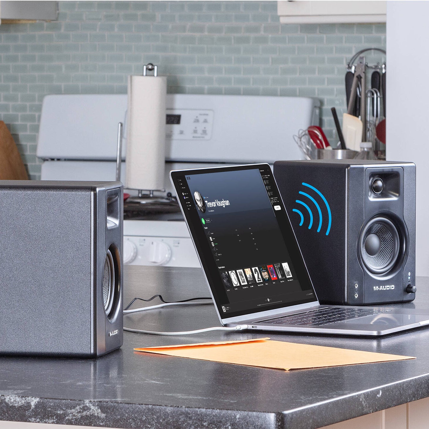 M-Audio BX4 BT desktop speakers with black finish, compact design, and control knobs on the front for high-quality audio.