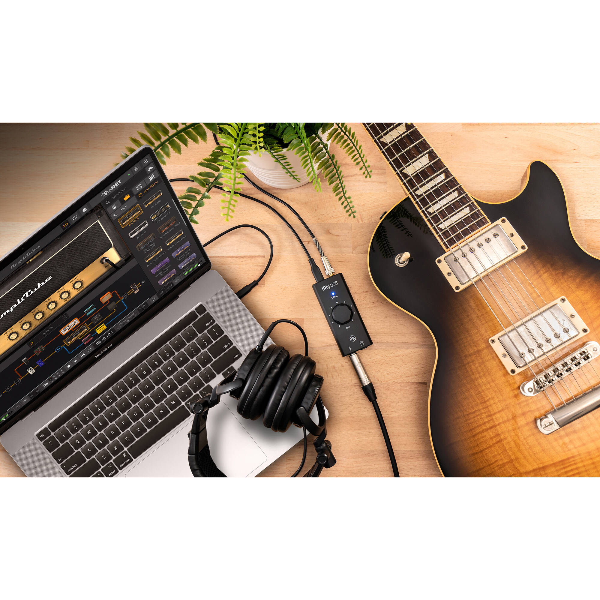 IK Multimedia iRig USB audio interface with input and output ports, compact design, and connection cables visible.