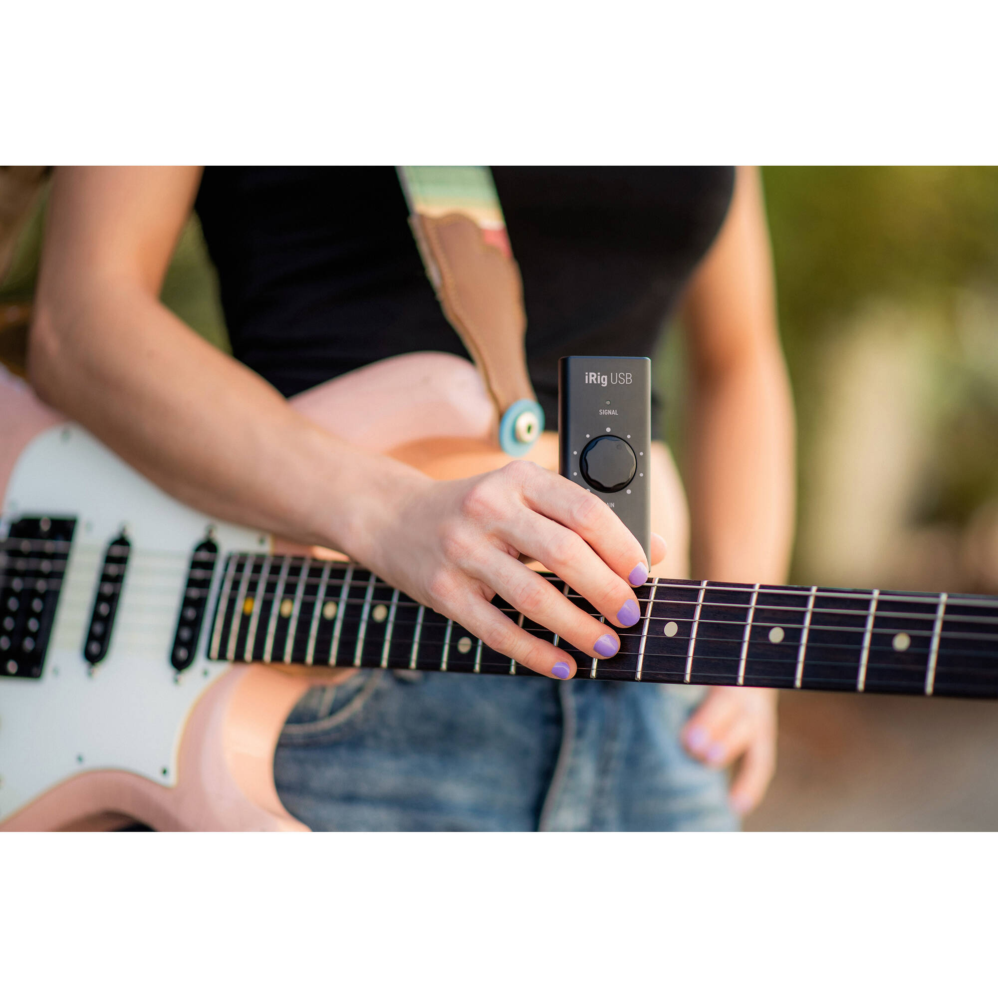 IK Multimedia iRig USB audio interface with input and output ports for connecting musical instruments to computers.