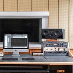 Adam Audio A77H mid-field and main studio monitor speakers shown from front, featuring sleek black design and speaker cones.