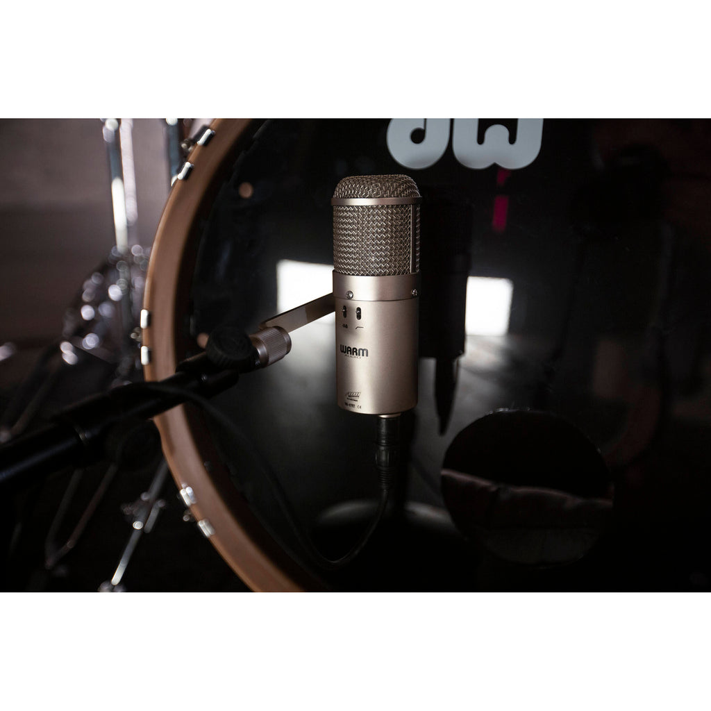 Warm Audio WA-47F condenser microphone with vintage-style grille and professional audio interface showing the microphone mounted on a stand.