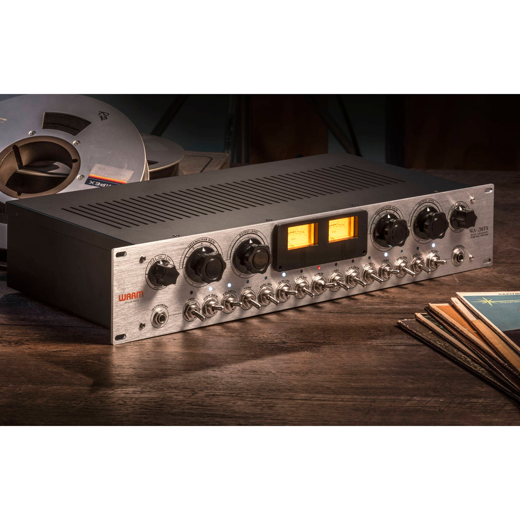 Warm Audio WA-2MPX microphone preamp with controls and input/output jacks, shown on a professional audio setup.