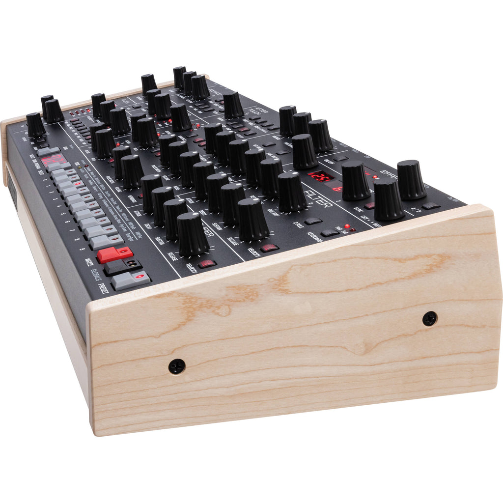 Sequential Trigon-6 desktop synthesizer showing front panel with knobs, switches, and colorful patch points for sound design.