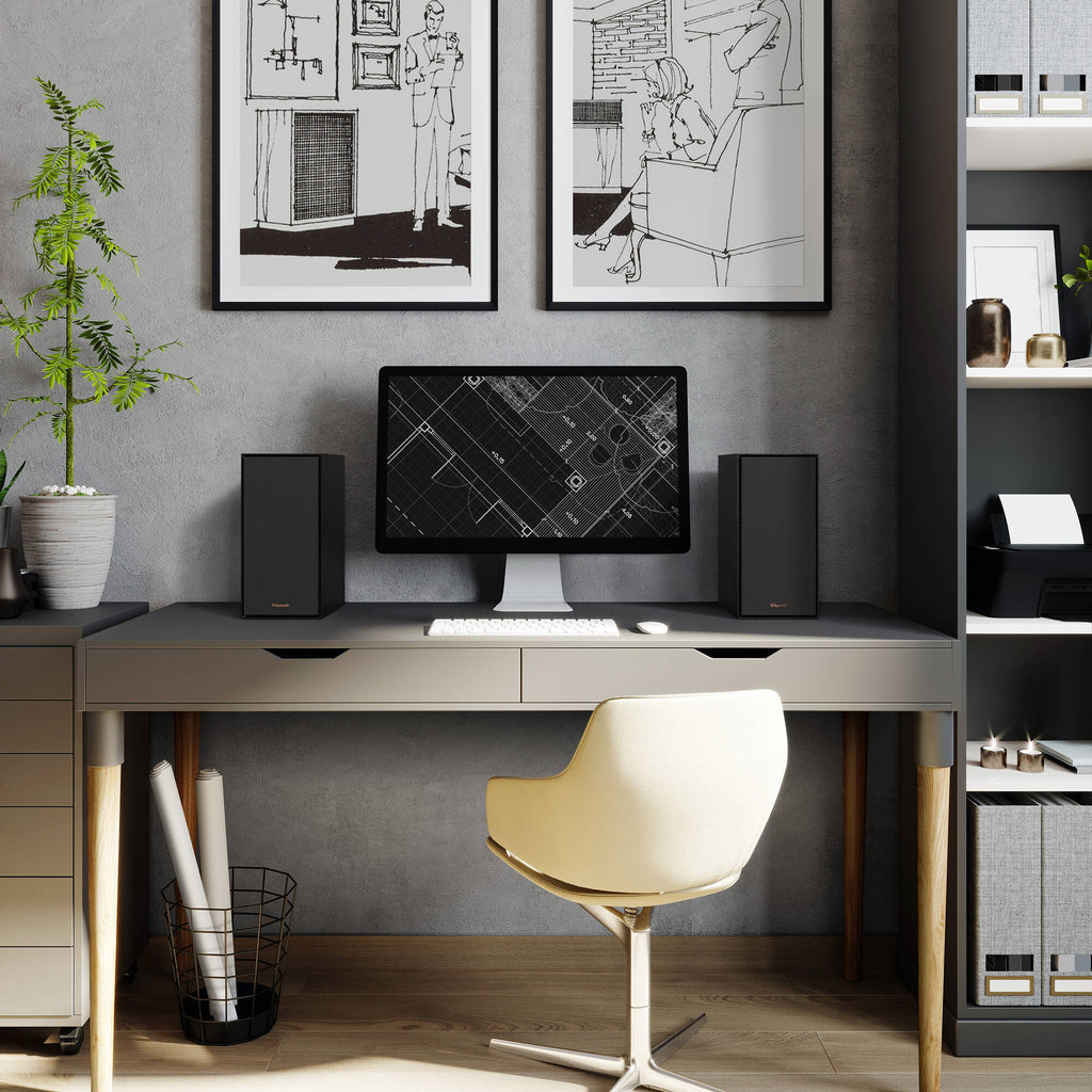 Black Klipsch R-40PM wireless speakers with wooden finish, compact design, and front-facing controls, ideal for home audio.