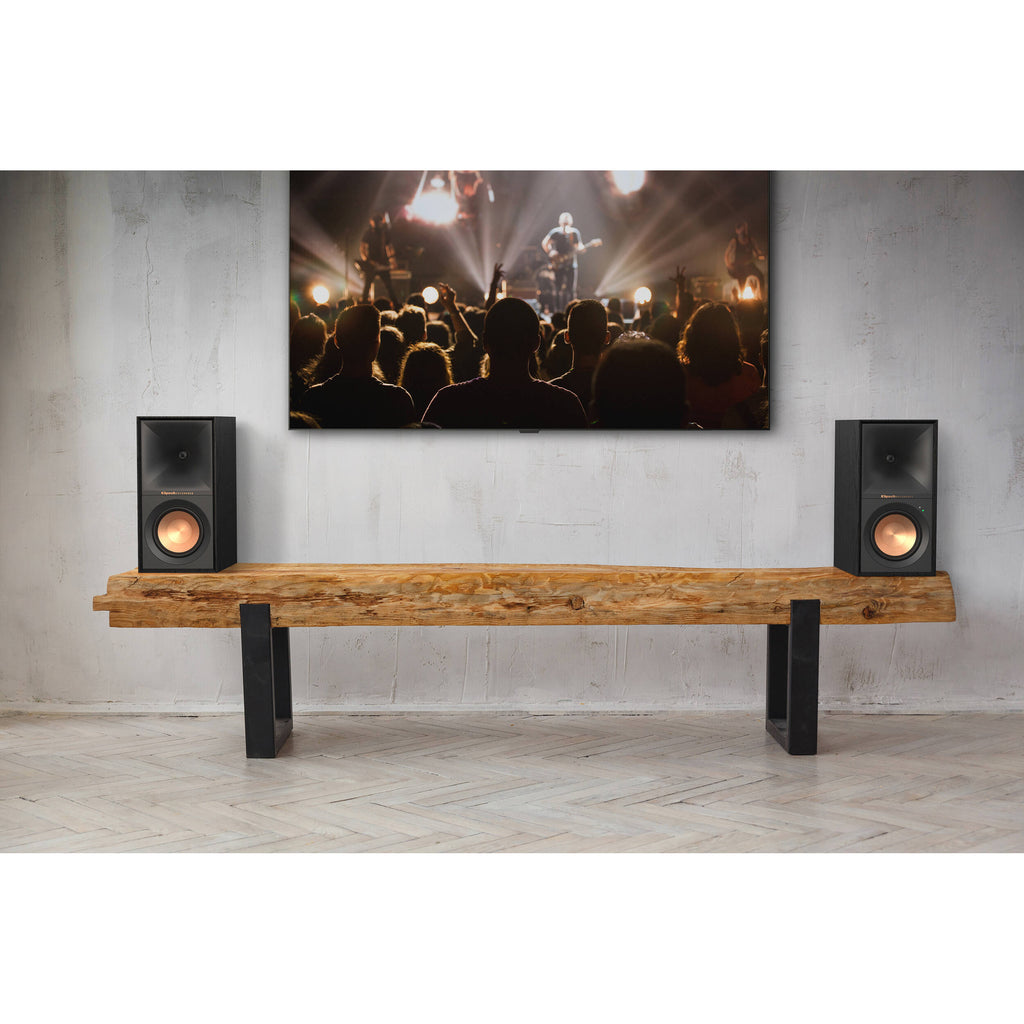 Black Klipsch R-50PM wireless speakers with sleek design and compact size, showcasing their front speaker grille and control panel.