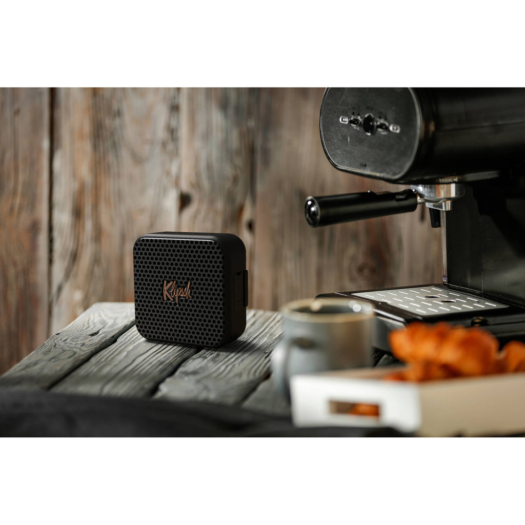 Klipsch Austin portable speaker with sleek black design and control buttons on top, ideal for portable audio enjoyment.