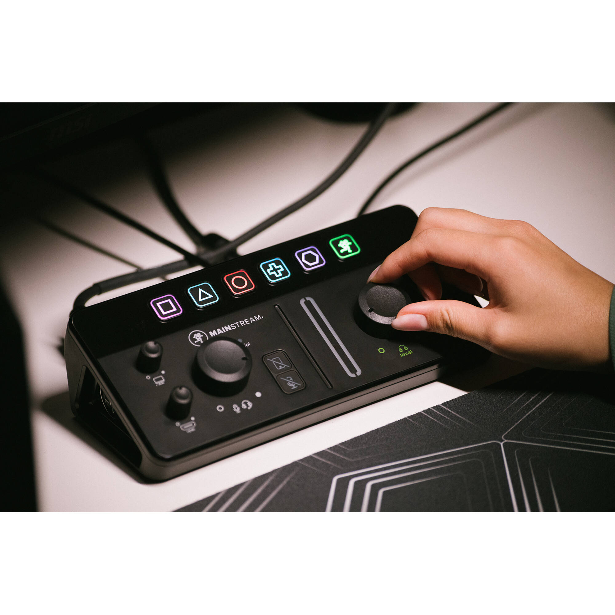 Mackie MainStream video streaming device with control interface, featuring buttons and display screen for live streaming setup.