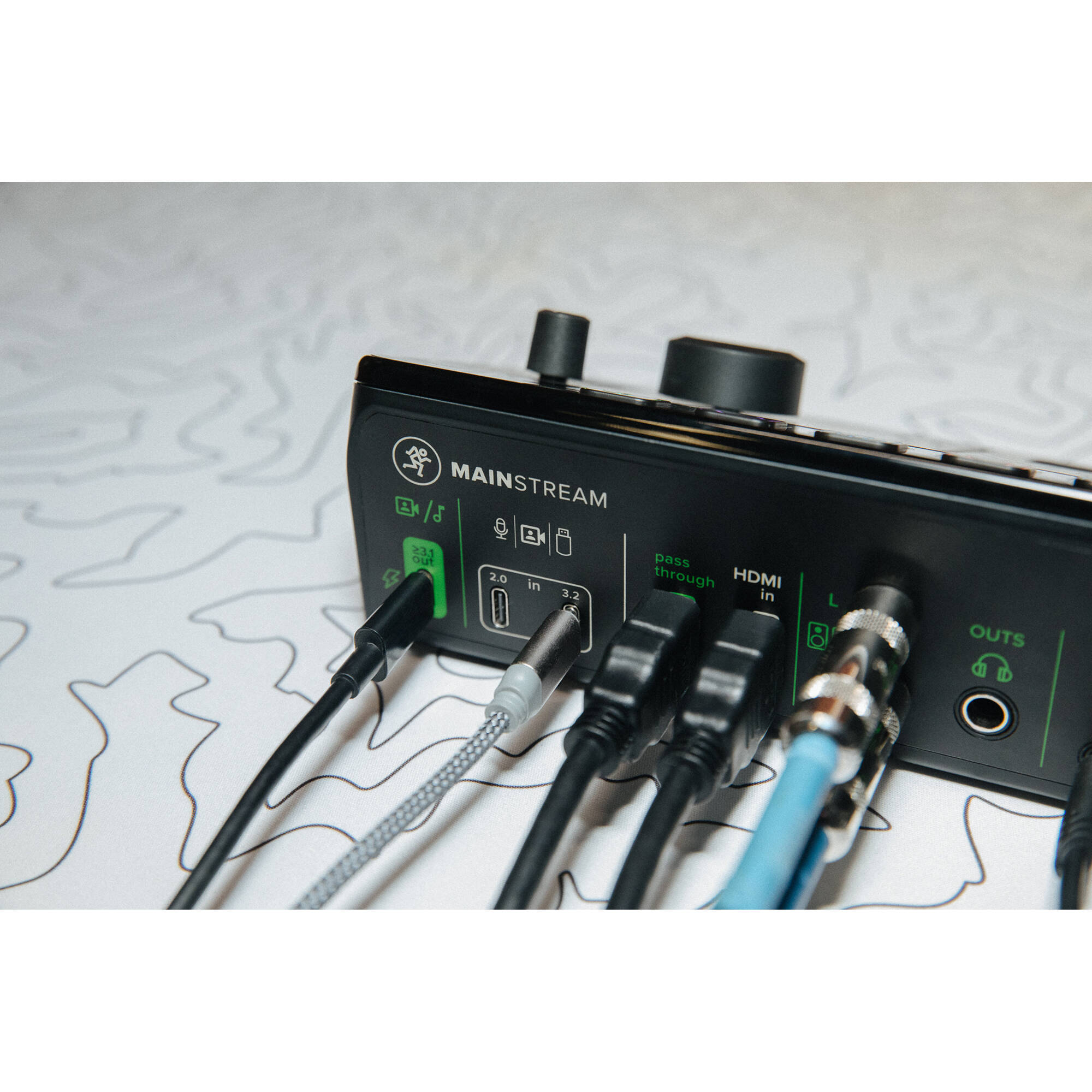 Mackie MainStream video streaming device with control interface, black rectangular design, and multiple connection ports.
