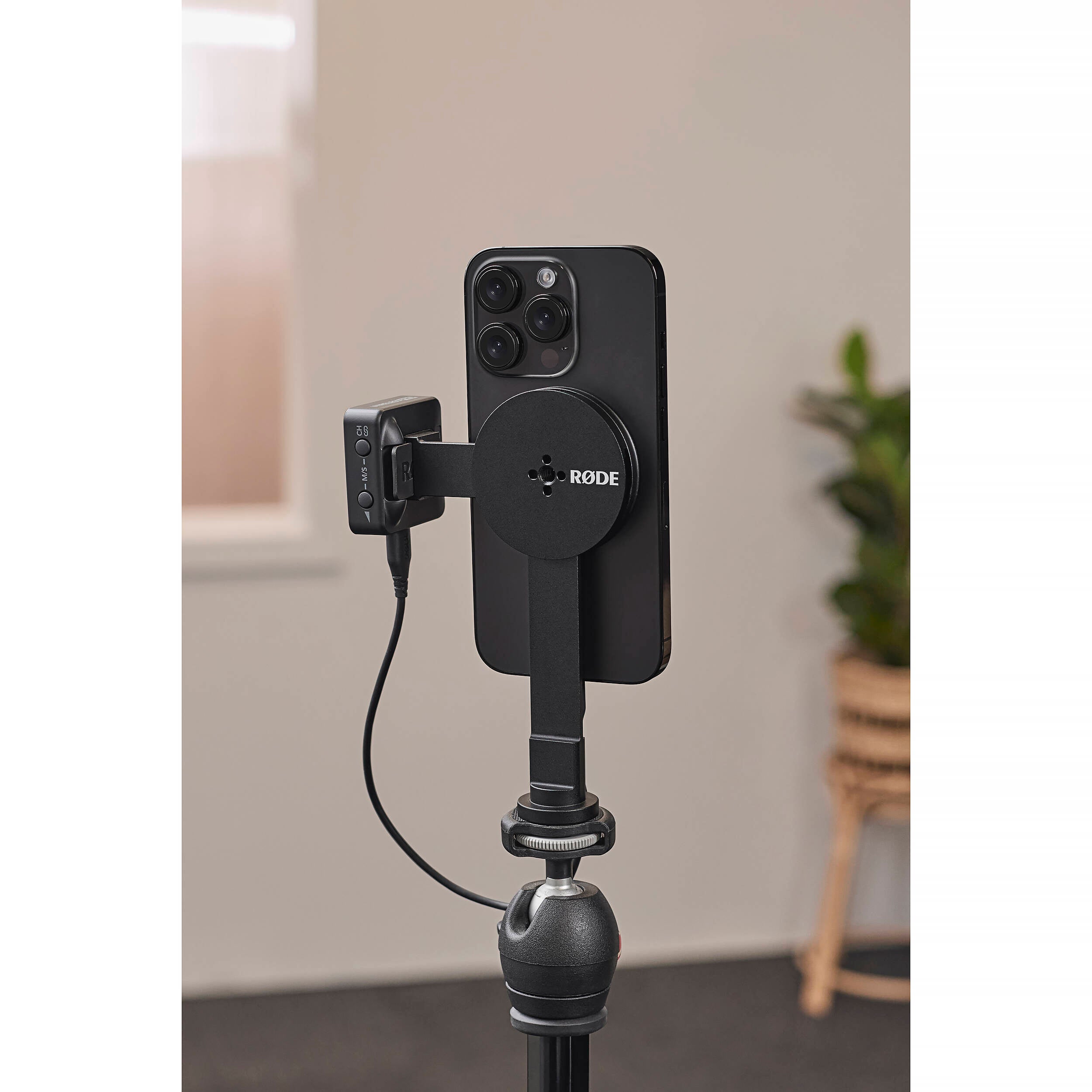 Rode magnetic mount attached to a tripod, supporting audio or video equipment with a sturdy, secure connection.