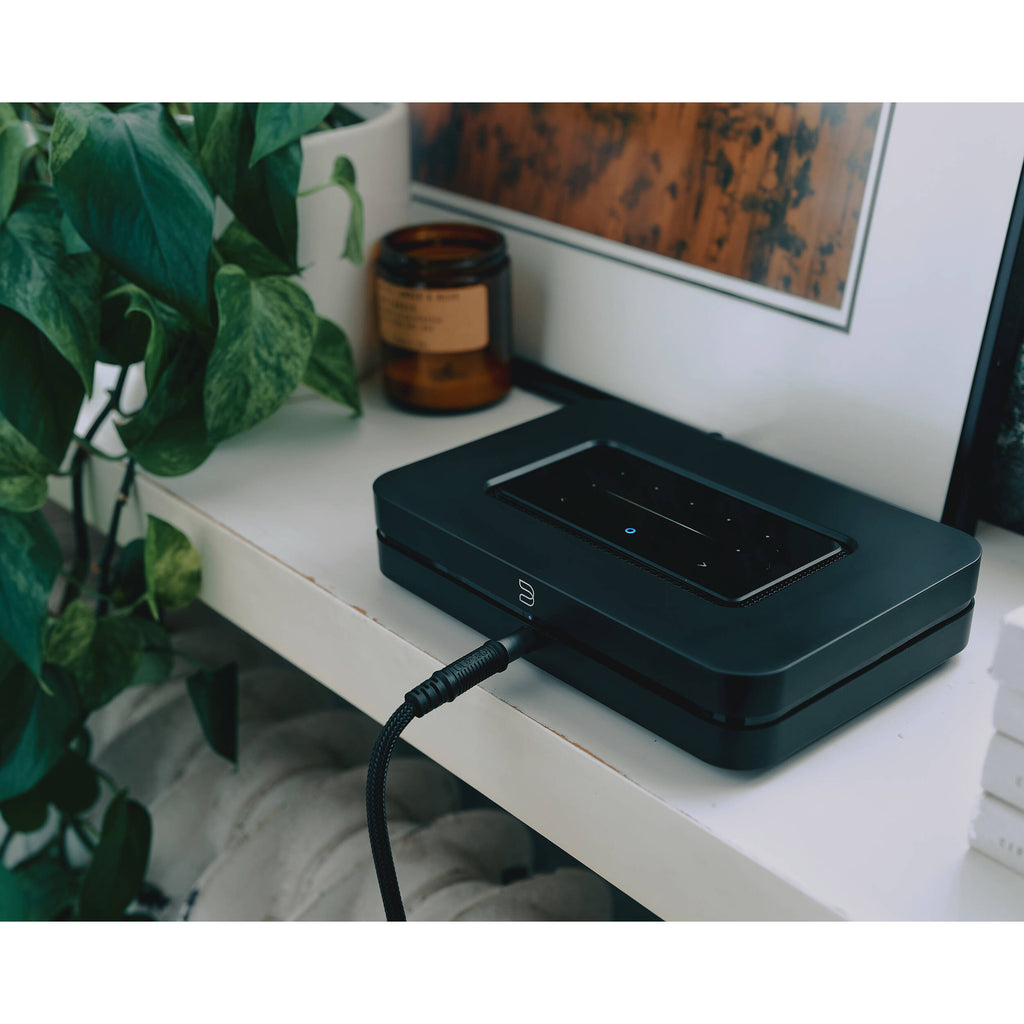 Bluesound Node 2025 black music streamer with sleek design, digital display, and multiple connectivity options.