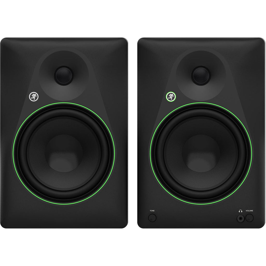 Mackie CR8BT desktop speakers with black finish, featuring control knobs and Bluetooth connectivity, on a wooden desk setup.