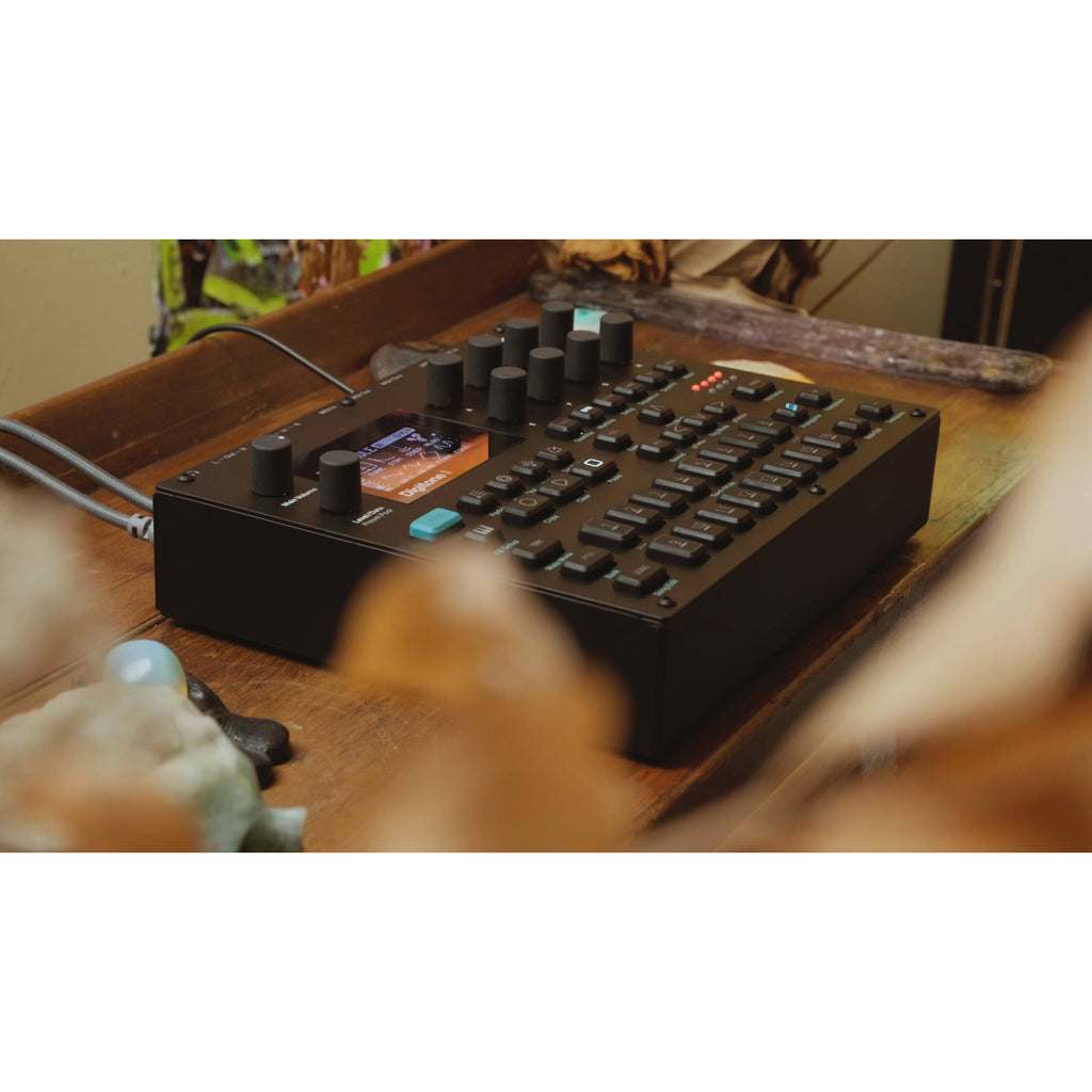 Elektron Digitone II synthesizer with a sleek black design and control knobs, displayed on a music production setup.