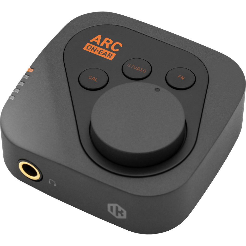 IK Multimedia ARC ON EAR headphone amplifier and DAC, compact device with controls and ports for high-quality audio output.