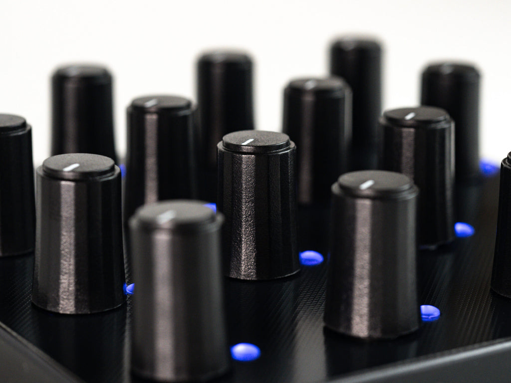 Close-up of Intech Studio PO16 Series 3 MIDI controller with knobs, buttons, and a sleek black design for music production.