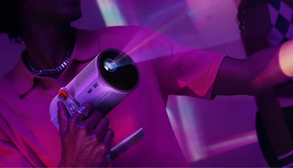 Xgimi Mogo 4 portable projector with lens and venting, compact design, displaying projected image on wall.