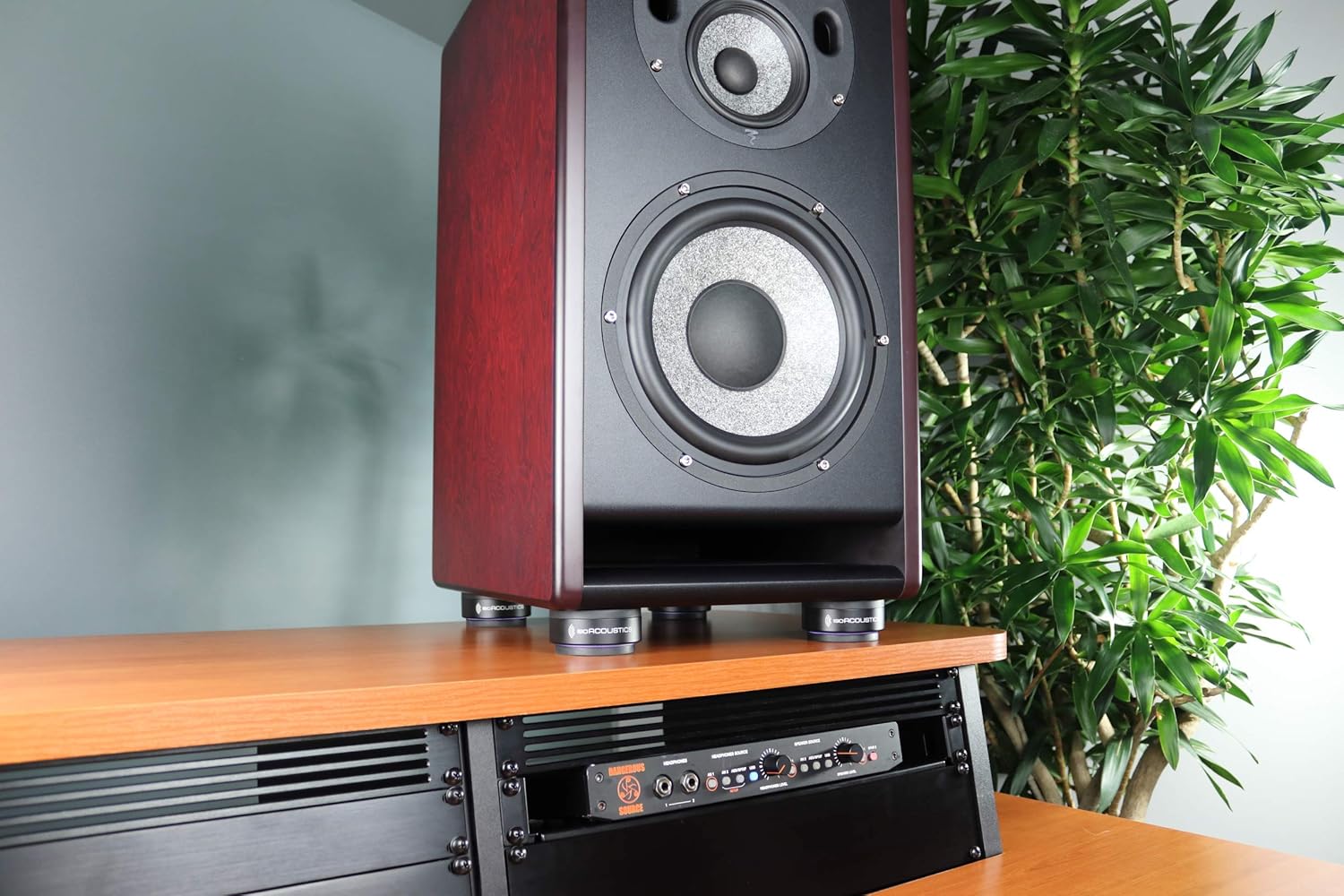 IsoAcoustics ISO-Puck 76 studio monitor stand isolator with four black rubber pads for audio equipment stability.