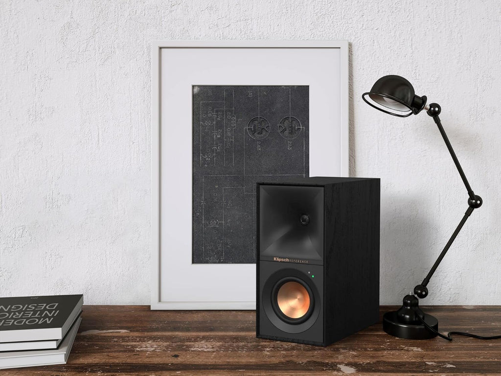 Black Klipsch R-40PM wireless speakers with sleek design and front-facing speakers, ideal for high-quality audio.