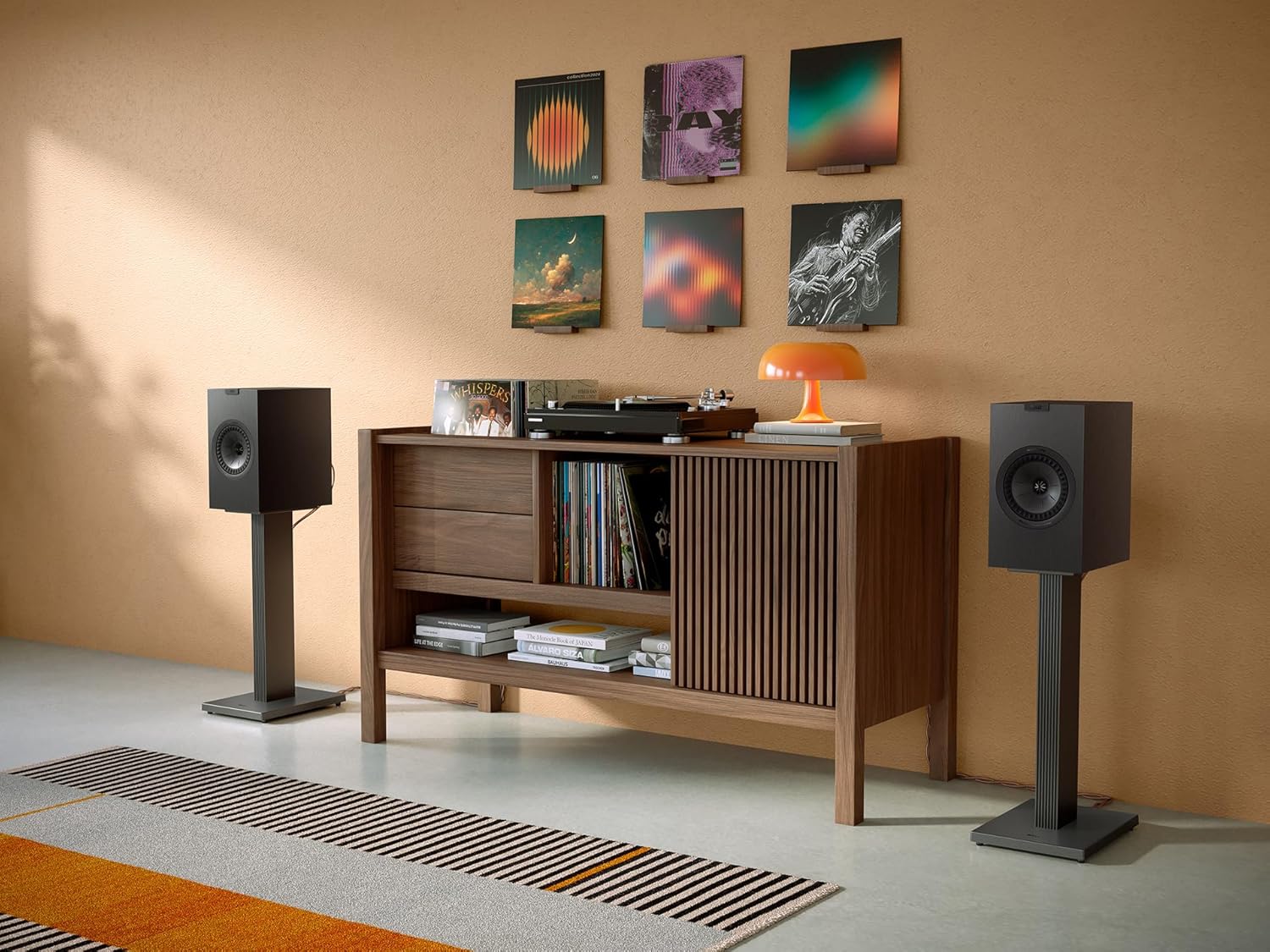KEF Q1 Meta passive bookshelf speakers with sleek black finish and front grille, designed for high-quality home audio.