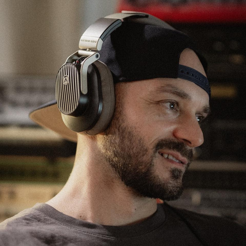 Austrian Audio The Arranger wired headphones with over-ear design and plush ear cushions, showcasing their sleek black finish.