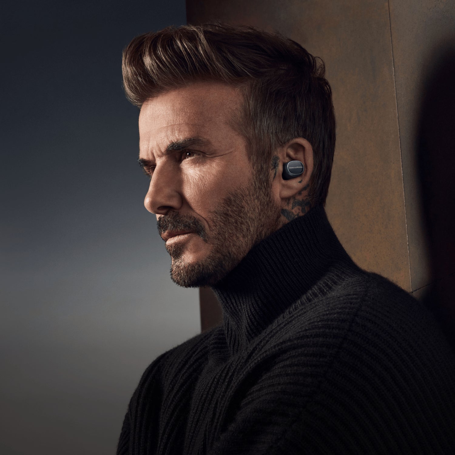 Wireless in-ear headphones by Bowers & Wilkins Pi8 model, showcasing sleek design and compact earbuds on a dark background.
