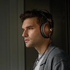 Meze Audio 99 Classics 2nd Gen wired headphones with wood ear cups and black headband, close-up view of the headphones.