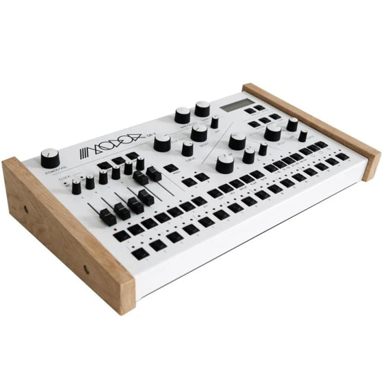 Modor DR-2 drum machine with wooden side panels, featuring control knobs, buttons, and a digital display for music production.