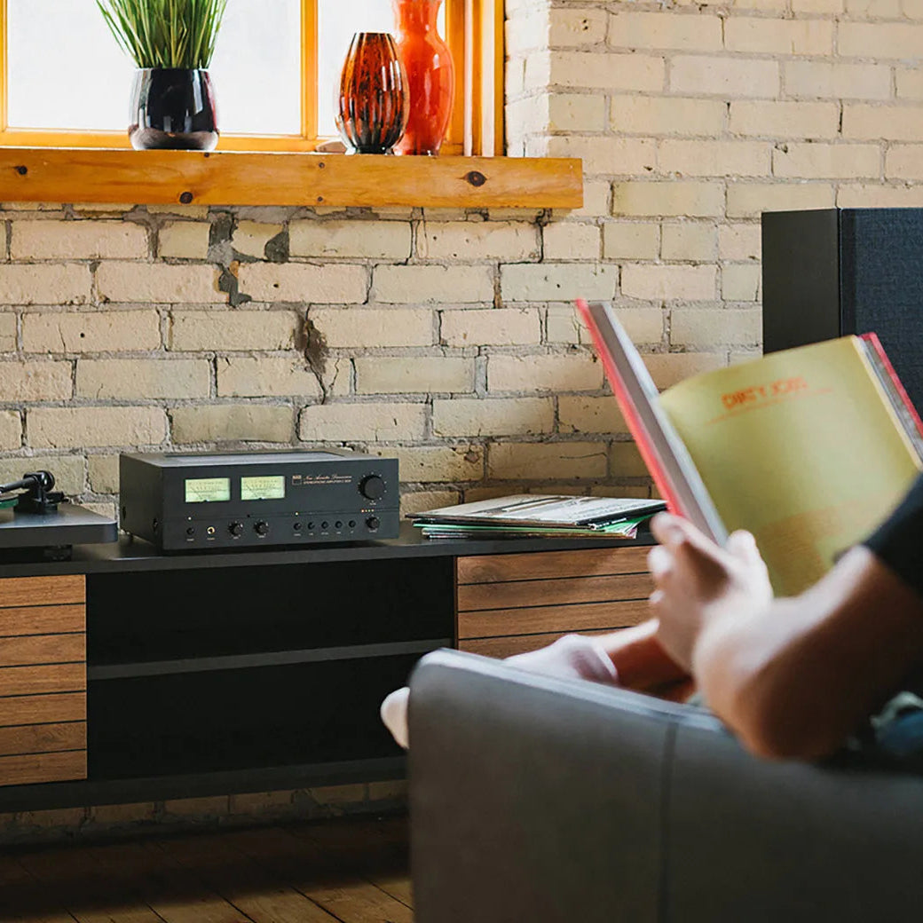 NAD C 3030 stereo amplifier with sleek black design and control knobs, showcasing high-quality audio equipment.