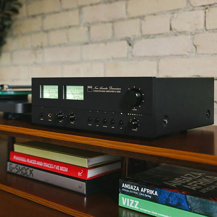 NAD C 3030 stereo amplifier with sleek black design and front control knobs, showcasing high-fidelity audio equipment.