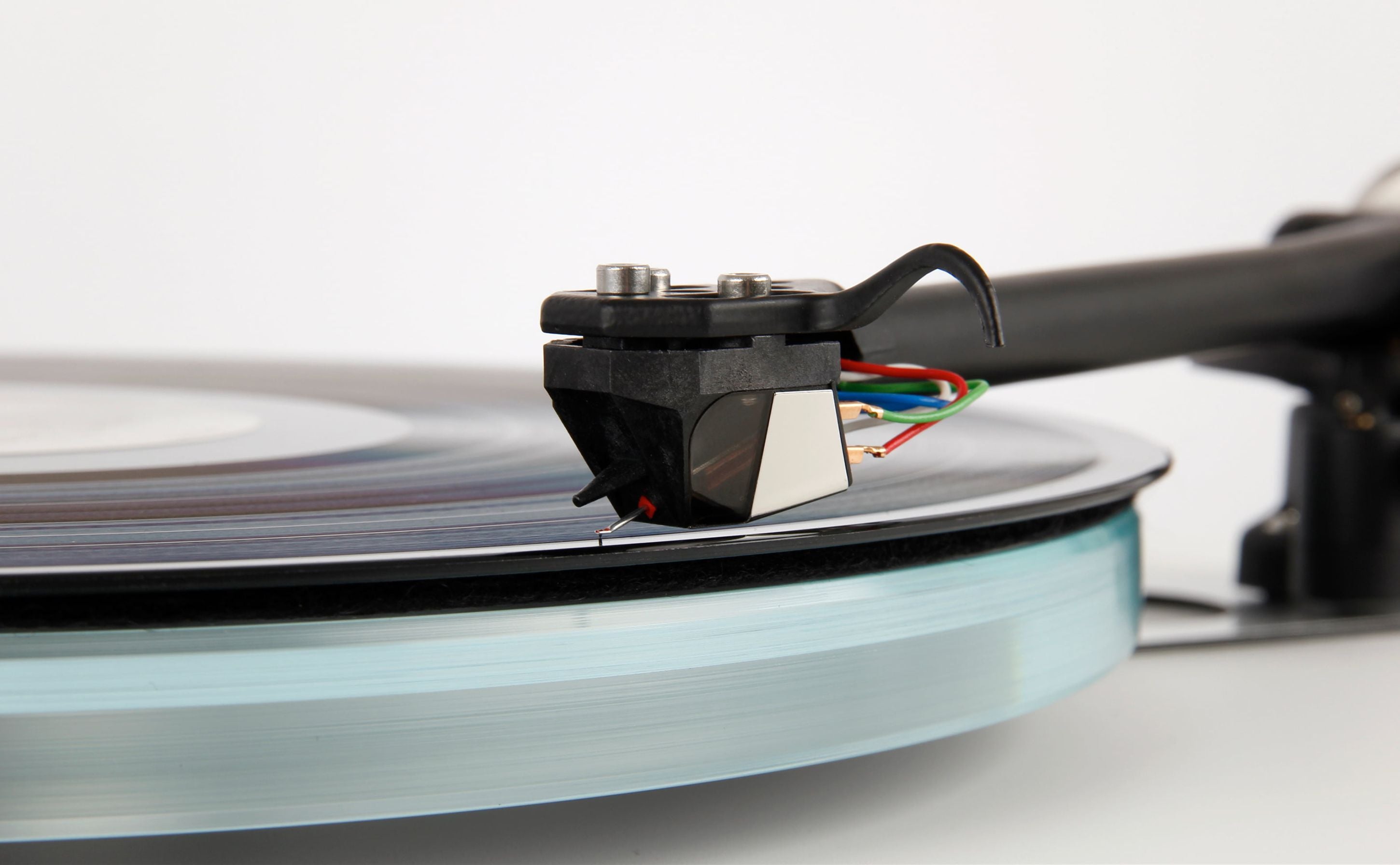 Rega ND5 turntable cartridge with sleek design, mounted on tonearm for high-quality vinyl playback.