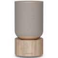 Bang & Olufsen Beosound Balance wireless speaker in natural oak finish, showcasing its sleek, modern design and front view.