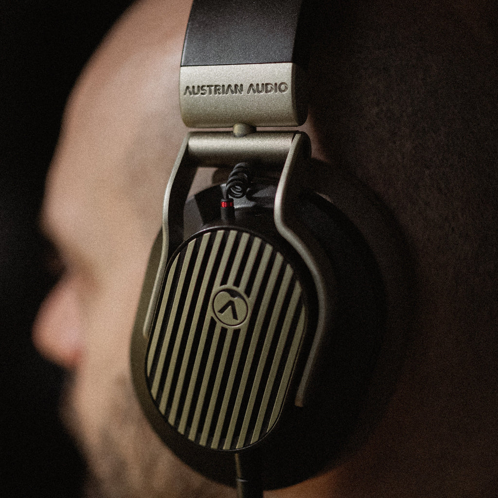 Austrian Audio The Arranger wired headphones with over-ear design and black finish, featuring cushioned ear cups and adjustable headband.