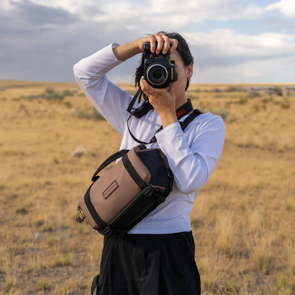 Wandrd Rogue Sling bag in Atacama Clay color, designed for video equipment storage, showing its compact, durable outdoor gear style.