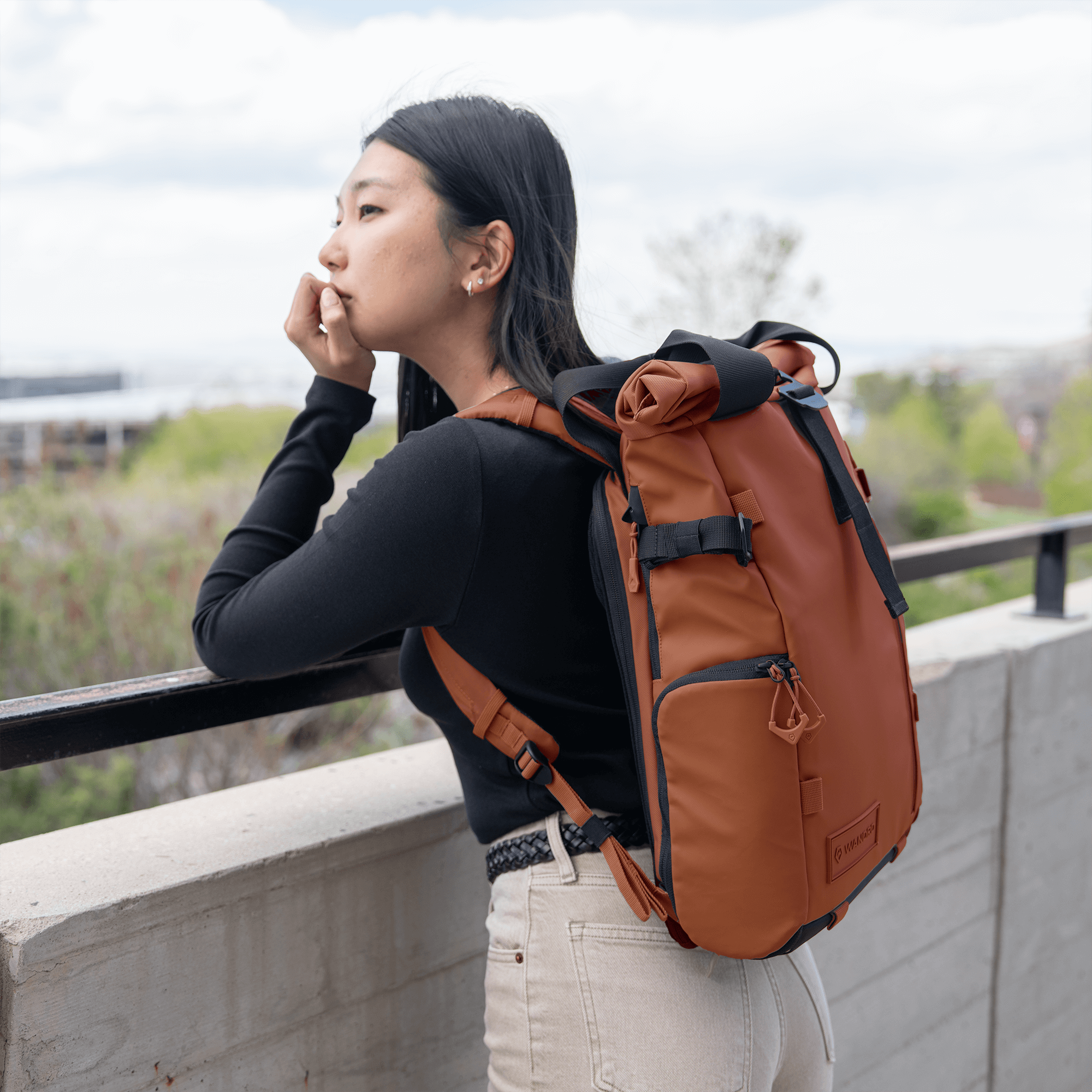 Wandrd Prvke 15L photo bundle camera bag in Sedona Orange with lifestyle setting, showcasing versatile video equipment storage.