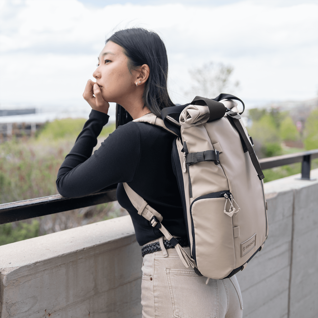 Wandrd Prvke 15L photo bundle outdoor camera bag in Yuma Tan with lifestyle scene showing storage compartments and shoulder strap
